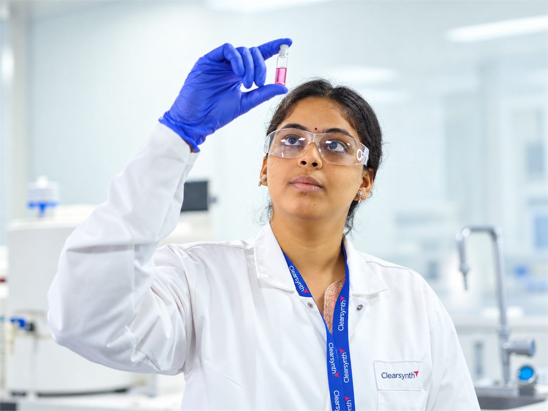 Clearsynth scientist reviewing an analytical standard vial